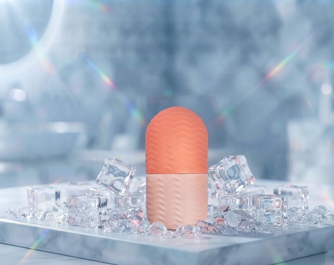 LuxeIce Facial Ice Roller in pink with rose petals and dragon fruit frozen inside the ice head, styled on ice cubes