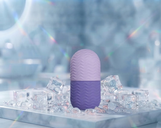 LuxeIce Facial Ice Roller in purple with lavender and violet flowers frozen inside the ice head, styled on ice cubes
